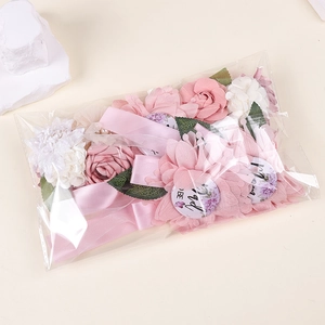 Detailed view of handmade fabric flowers and ribbons in a clear bag for party decor