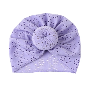Detail view of lavender hollow eyelet knit baby turban with central donut knot