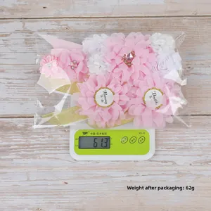 Detailed view of baby shower sash and corsage set weighing 62g in packaging