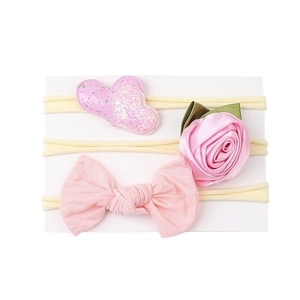 Set of 3 pink baby headbands featuring glitter heart, satin rose, and cotton bow styles