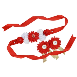 Macro detail of red flower maternity sash set with Mommy To Be and Daddy To Be badges