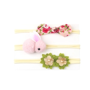 Set of 3 baby elastic headbands featuring pink floral bow, plush bunny, and gold flower
