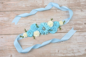 Detail of light blue floral sash for maternity gowns with pearls and rhinestones