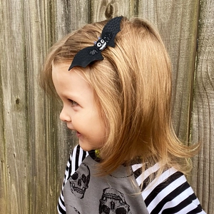 Halloween bat hair clip for kids featuring felt fabric and a cute cartoon smiley face