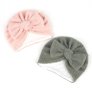 Détail de bonnets turban bébé en polaire teddy double couche avec grands nœuds rose et gris