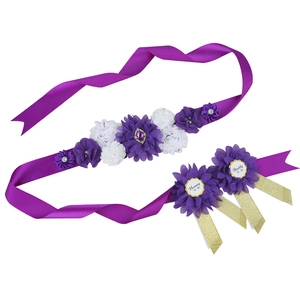 Close-up of baby shower sash with chiffon flowers and Mommy To Be badges