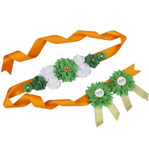 Orange baby shower sash and pins set with green fabric flowers for mommy and daddy to be