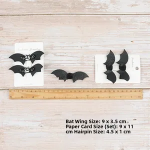 Detailed view of Halloween bat hair clips set with size measurements on wood background