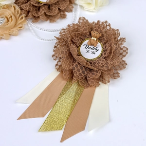 Detailed view of Daddy To Be corsage with brown lace flower and cute bear accent