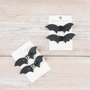 Detail of Halloween black leather bat hair clips with bow design on display card