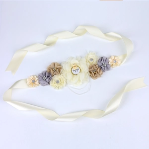 Close-up of Mommy To Be floral sash with cute bear and pearls for baby shower party