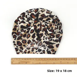 Leopard print baby turban hat with a large bow showing dimensions 19x18 cm size detail