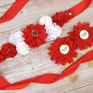 Close-up of Mommy to Be and Daddy to Be floral sash and badges for baby shower party