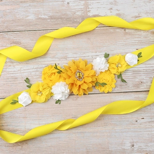 Detailed macro view of yellow sunflower floral belt with white roses and faux pearls