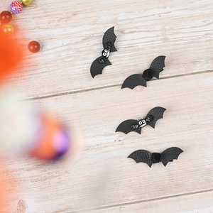 Set of four Halloween bat hair clips made of textured black faux leather with cute details