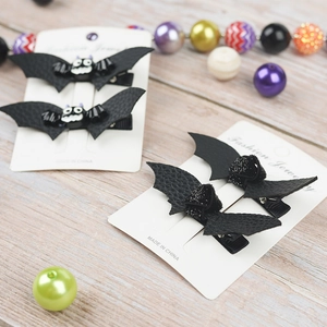 Detail of Halloween bat hair clips with black faux leather and glitter bows for girls