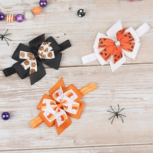 Set of Halloween baby bow headbands featuring pumpkin and candy corn prints