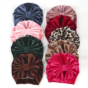 Selection of velvet baby turban hats with large bows in nine various colors and leopard print