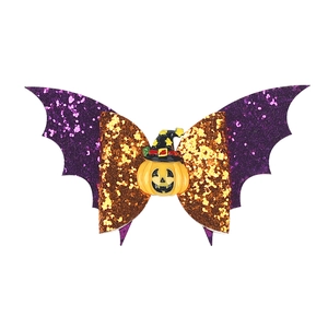 Halloween glitter hair clip featuring purple bat wings and orange pumpkin bow design