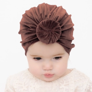 Brick red velvet infant turban hat with pleated design and soft round ball knot decoration