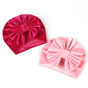 Detail of soft velvet baby turbans with large bows in rose and light pink colors