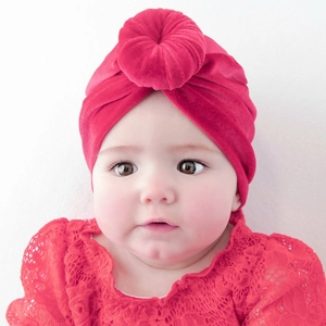Detail of rose pink velvet baby turban hat with a twisted donut knot and soft texture