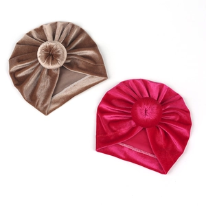 Detailed macro view of soft velvet baby turban knots in dark khaki and rose pink colors