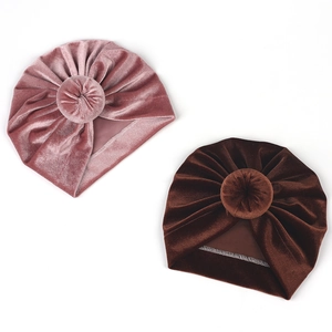 Detail of velvet baby turban hats in pink and brown with twisted knot design