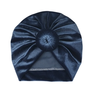 Detailed view of the dark blue velvet baby turban hat with a stylish donut knot design