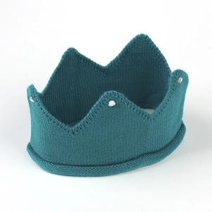 Detail of teal knit crown hat showing sparkling silver rhinestones and texture