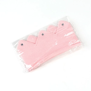 Detail of pink knitted crown hat for babies with sparkling rhinestones decoration