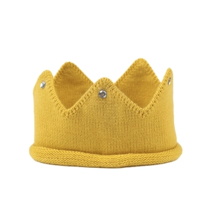 Detail of ginger yellow knitted crown hat with sparkling rhinestone accents for toddlers