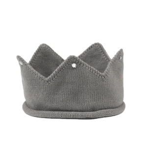 Close-up of gray knitted baby crown hat with sparkling rhinestone detail and rolled edge