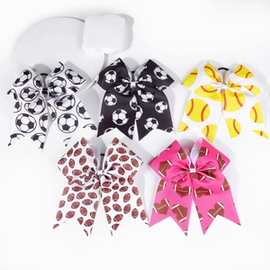 Detail of five-piece set of sports-themed ribbon bows with football and soccer prints