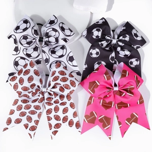 Detail of four-piece sports-themed hair bows with soccer and football patterns on elastic bands