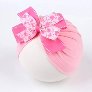 Bonnet turban rose pour bébé avec double nœud et motif cœur pour nouveau-nés