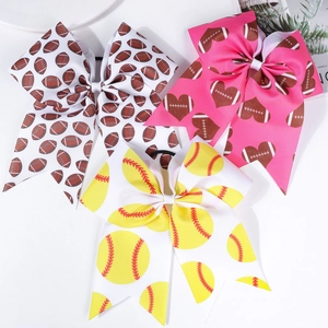 Detailed view of cheerleader hair bows with football and softball patterns on white background