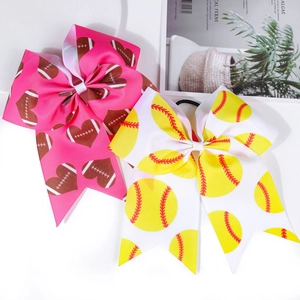 Detail of pink and white cheerleader hair bows with football and softball patterns