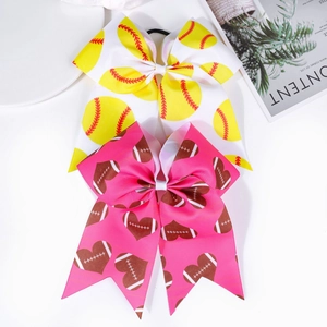Close-up of cheerleader hair bows with softball and heart football prints on grosgrain