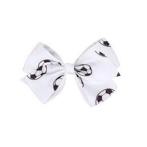 Detailed view of white ribbon hair clip with high-density soccer ball print patterns