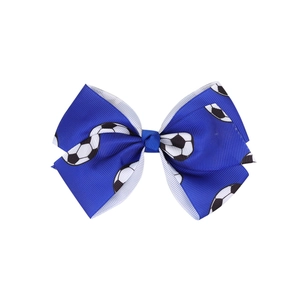 Macro detail of blue grosgrain hair bow with football print and layered ribbon edges