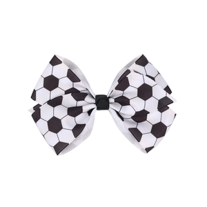 Detail view of soccer pattern grosgrain ribbon double bow hair clip with black and white texture