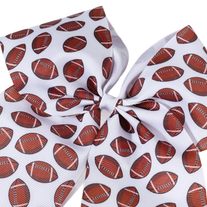 Classic white grosgrain ribbon hair bow featuring a detailed American football pattern print