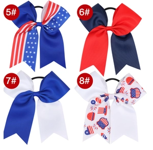 Detailed close-up of four American flag themed cheerleader hair bows with star patterns