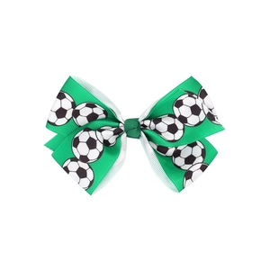Detail of green ribbon hair clip with soccer ball patterns for kids sports accessories