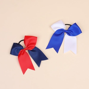 Detail of red and blue grosgrain ribbon bows with swallowtail design on elastic hair bands