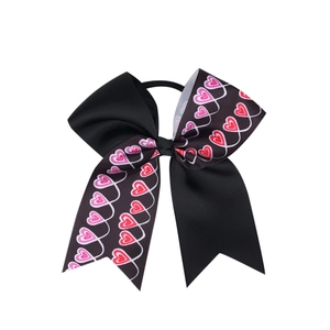 Détail d'un nœud papillon en ruban gros-grain à motif cœur avec élastique cheveux