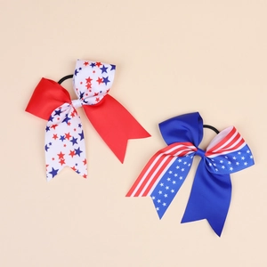 Detail view of two patriotic Independence Day hair bows with stars and stripes pattern