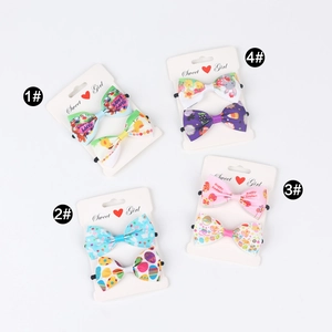 Detailed close-up of four Easter ribbon bow hair clips with bunnies and colorful eggs