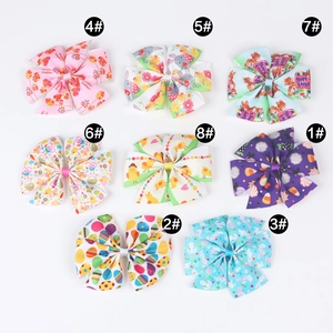 Detail view of eight Easter bow hair clips with rabbits and eggs on white background